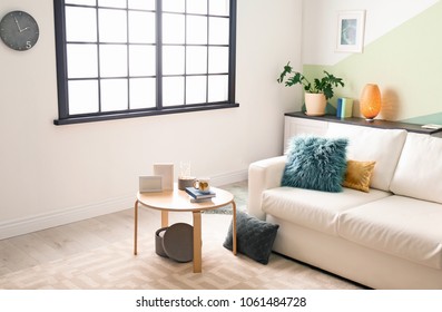 Stylish living room interior with comfortable sofa and table - Shutterstock ID 1061484728