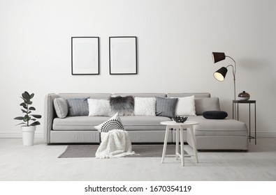 Stylish living room interior with comfortable sofa - Shutterstock ID 1670354119