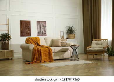 Stylish living room interior with comfortable sofa and armchair