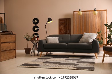 Stylish living room interior with comfortable dark sofa - Shutterstock ID 1992328067