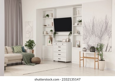 Stylish living room interior with comfortable sofa, TV set and houseplants - Shutterstock ID 2332135147