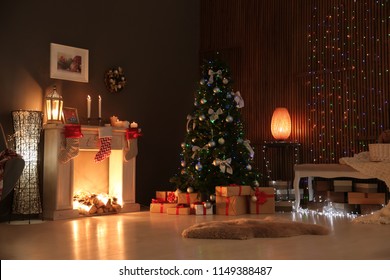 Stylish Living Room Interior With Decorated Christmas Tree At Night