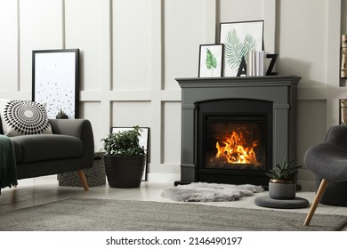 Stylish living room interior with electric fireplace and comfortable furniture