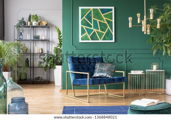 Stylish living room interior idea with green, blue\
and gold colors
