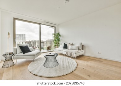 Stylish Living Room With White Sofa, Carpet And Black Coffee Table On It