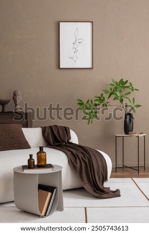 Stylish living space with a modern sofa, minimalist side table, and green plant against a warm beige wall. Accents like a brown throw and abstract art create a cozy, inviting atmosphere Mock up poster