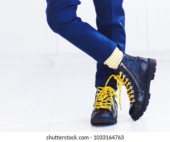 stylish look of patent leather ankle boots with yellow shoelaces and socks at young boy - Powered by Shutterstock