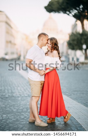 Stylish loving couple walking and laughing. Wedding shooting on the streets of Rome, Italy. 