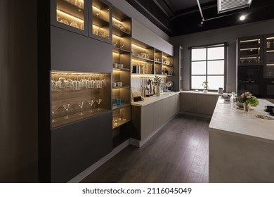 Stylish Luxury Kitchen Interior In An Ultra-modern Spacious Apartment In Dark Colors With Super Cool Led Lighting And An Island For Cooking