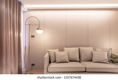 Stylish luxury living room with  beige leather sofa, gold stainless wall lamp and wallcovering in the background / luxury interior / copy space / - Shutterstock ID 1557674438