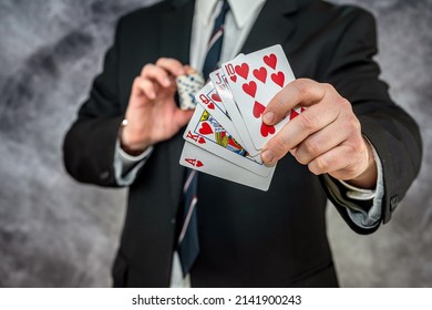 Stylish Man In Black Suit Holding Play Cards And Poker Chips In Casino. Gambling  Playing Concept