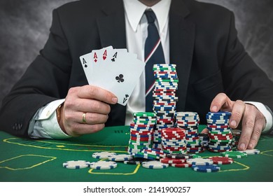 Stylish Man In Black Suit Holding Play Cards And Poker Chips In Casino. Gambling  Playing Concept