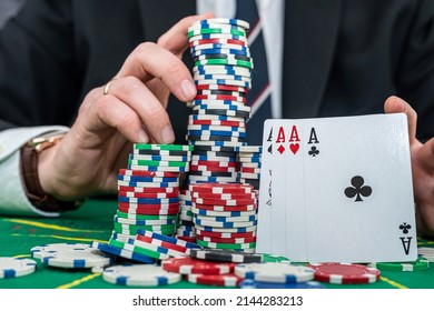 Stylish Man In Black Suit Holding Play Cards And Poker Chips In Casino. Gambling  Playing Concept