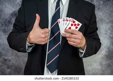 Stylish Man In Black Suit Holding Play Cards And Poker Chips In Casino. Gambling  Playing Concept