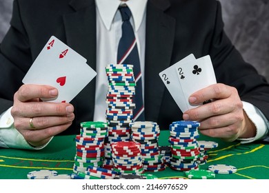 Stylish Man In Black Suit Holding Play Cards And Poker Chips In Casino. Gambling  Playing Concept