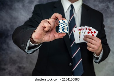 Stylish Man In Black Suit Holding Play Cards And Poker Chips In Casino. Gambling  Playing Concept