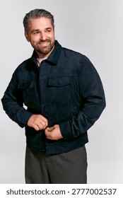 A stylish man buttoning his jacket, exuding confidence and charm in a contemporary atmosphere.