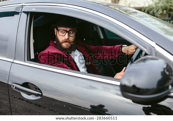 stylish man driving a luxury
car