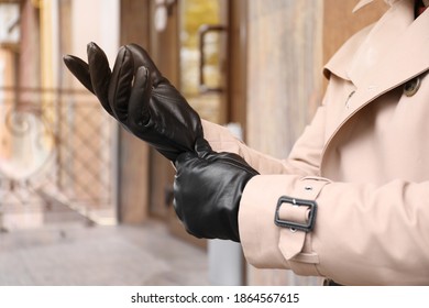 Stylish Man Putting On Black Leather Gloves Outdoors, Closeup