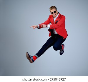 Stylish Man In Red Jacket Having Fun Jumping 