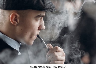 stylish man in retro outfit, smoking wooden pipe. sherlock holmes look cosplay.  england in 1920s theme. fashionable confident gangster. atmospheric moments