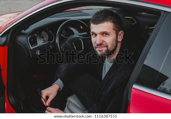 Stylish man\
sitting in a car, bearded man in stylish jacket, man in sunglasses,\
man in luxury car, hairstyle, pretty, attractive, rich, hand watch,\
jeans, busy, phone work,\
designer
