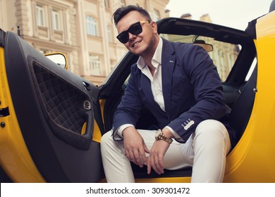 Stylish man sitting in sport car