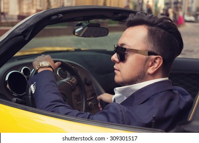 Stylish man sitting in sport car