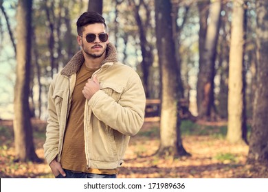 Stylish Man With Sunglasses Posing In Autumn Park