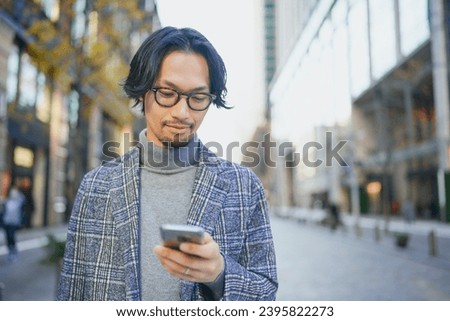 Stylish man using a smartphone in the city