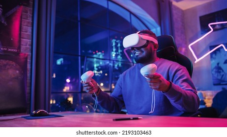 Stylish Man Using Virtual Reality Headset With Controllers At Home In Loft Apartment. Young African American Male Surfing The Web, Spending Time In VR Digital Office. POV From Screen Perspective.