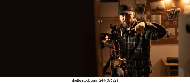 Stylish Mechanic repairing bicycle in garage in the evening. Banner. Copy space - Powered by Shutterstock