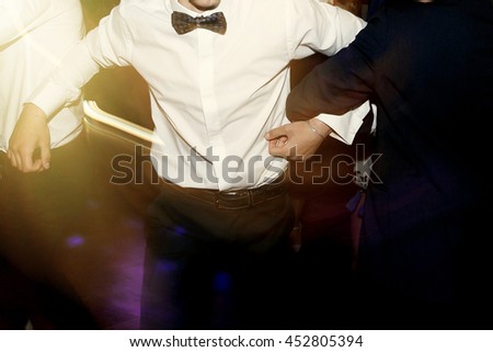 stylish men having fun and dancing at party in restaurant, reception at luxury wedding, rich graduation at school or university