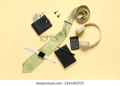 Stylish men's accessories and modern headphones on yellow background - Powered by Shutterstock