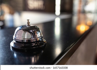 Stylish Metal Bell For Calling A Bartender Or Waiter On The Bar Counter. Bell Restaurant On The Bar With Bokeh