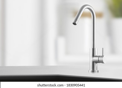 Stylish Metallic Crane At The Kitchen.Shiny Faucet At The Kitchen.Metal Crane In Close-up Photo.Modern Furniture. Silver Sink As Kitchen Equipment. Macro Photo With High Quality. Metallic Faucet.
