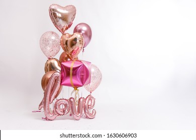 Stylish metallic pink balloons for Valentine's day, hen party or baby shower on a white background. The inscription 
