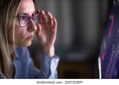 Stylish Mid-aged Woman Looking Concerned While Remote Working From Home, Staring At The Computer Screeen For Long Hours, Exhausting Her Eyes With Blue Light