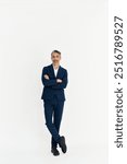 Stylish middle aged business man, mature professional executive, businessman leader fashion model wearing suit looking at camera isolated on white background posing for vertical full body portrait.