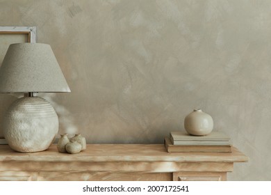 Stylish minimalistic monochromatic composition with design vases, elegant lamp and personal accessories. Copy space. Neutral colors. Template.