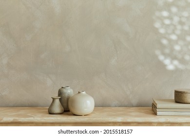 Stylish minimalistic monochromatic composition with design vases and personal accessories. Copy space. Neutral colors. Template.