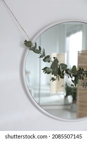 Stylish Mirror Decorated With Beautiful Eucalyptus Garland On White Wall