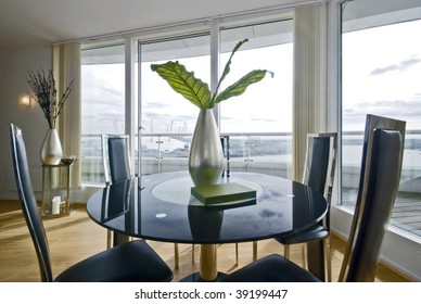 Stylish Modern Dining Room With A Round Glass Top Table And Seats For Four