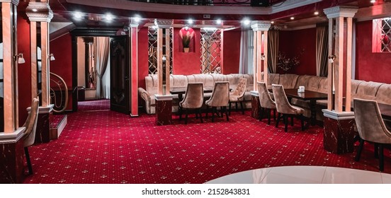 stylish modern premium restaurant. restaurant interior. columns in the center of the restaurant. upholstered furniture and red carpets. - Powered by Shutterstock