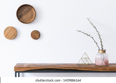 Stylish and modern scandinavian room interior with wooden console and rings on the wall, beautiful flowers in glassy vase. Design composition of home interior. White walls, copy space. Home decor. - Shutterstock ID 1439886164