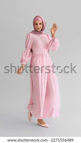 Stylish Muslim woman on light background