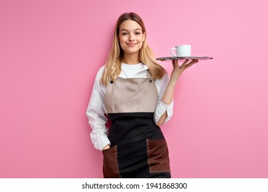 Stylish nice woman waitress in apron, offering cup of delicious tasty coffee - Shutterstock ID 1941868300