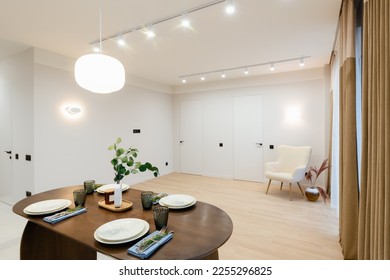 stylish oak studio kitchen with a dark table and a light kitchen