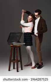 Stylish, Old Fashioned Couple Dancing Near Vinyl Player On Dark Grey Background