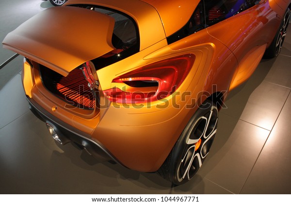 Stylish orange concept car at the automotive\
exhibition: back view, \
backlights